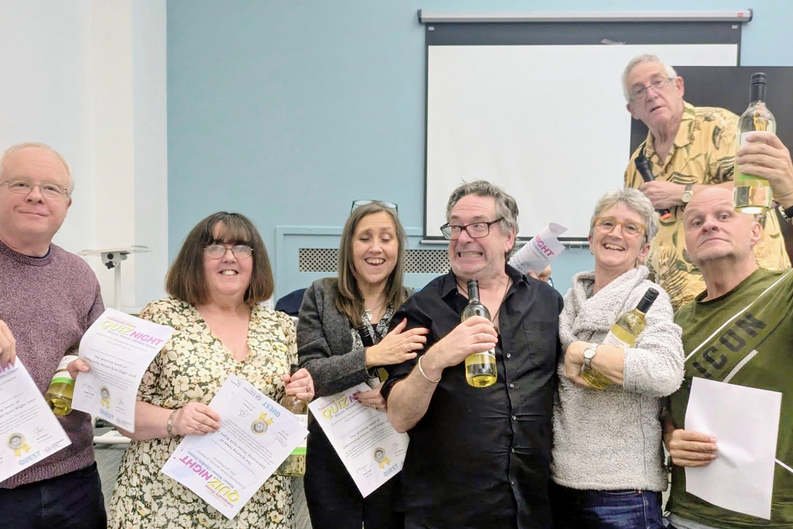 The Questionables holding their prizes and certificates